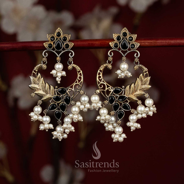 Statement oxidised silver earrings designed with black Monalisa stones, sculpted mandala chandbali form, peacock arch detailing and pearl bunch hangings for expressive ethnic wear - Sasitrends