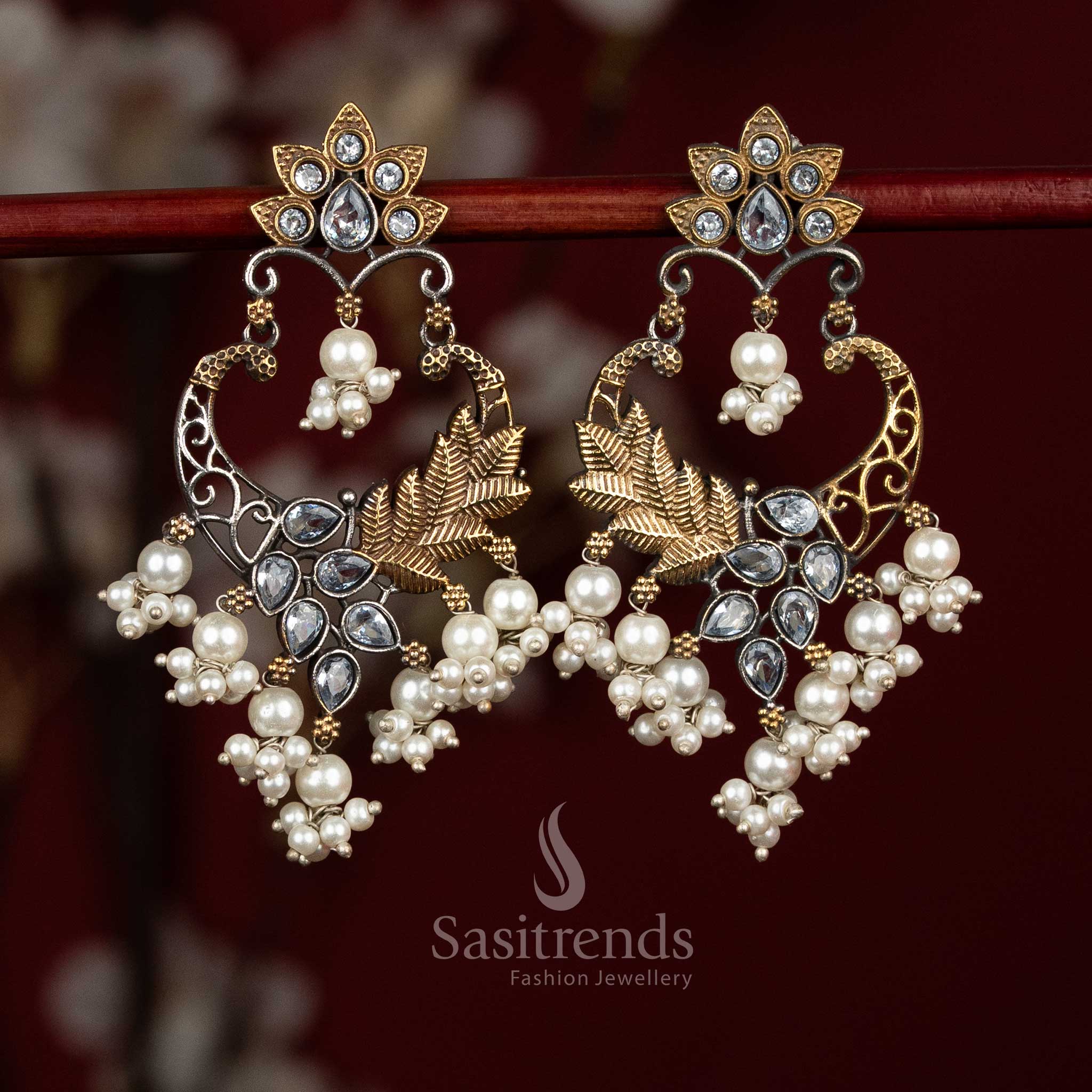 Refined oxidised silver earrings featuring white Monalisa stones, sculpted mandala chandbali design, peacock arch filigree and delicate pearl bunch hangings for sophisticated ethnic looks - Sasitrends