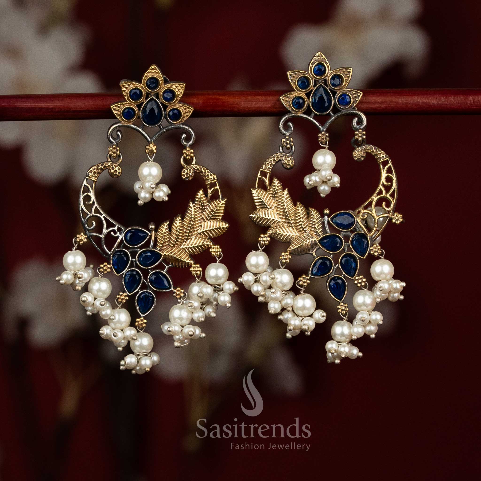 Cool toned dual tone oxidised 92.5 silver earrings designed with blue Monalisa stones, layered mandala chandbali structure, peacock arch accents and pearl drops for composed ethnic looks - Sasitrends
