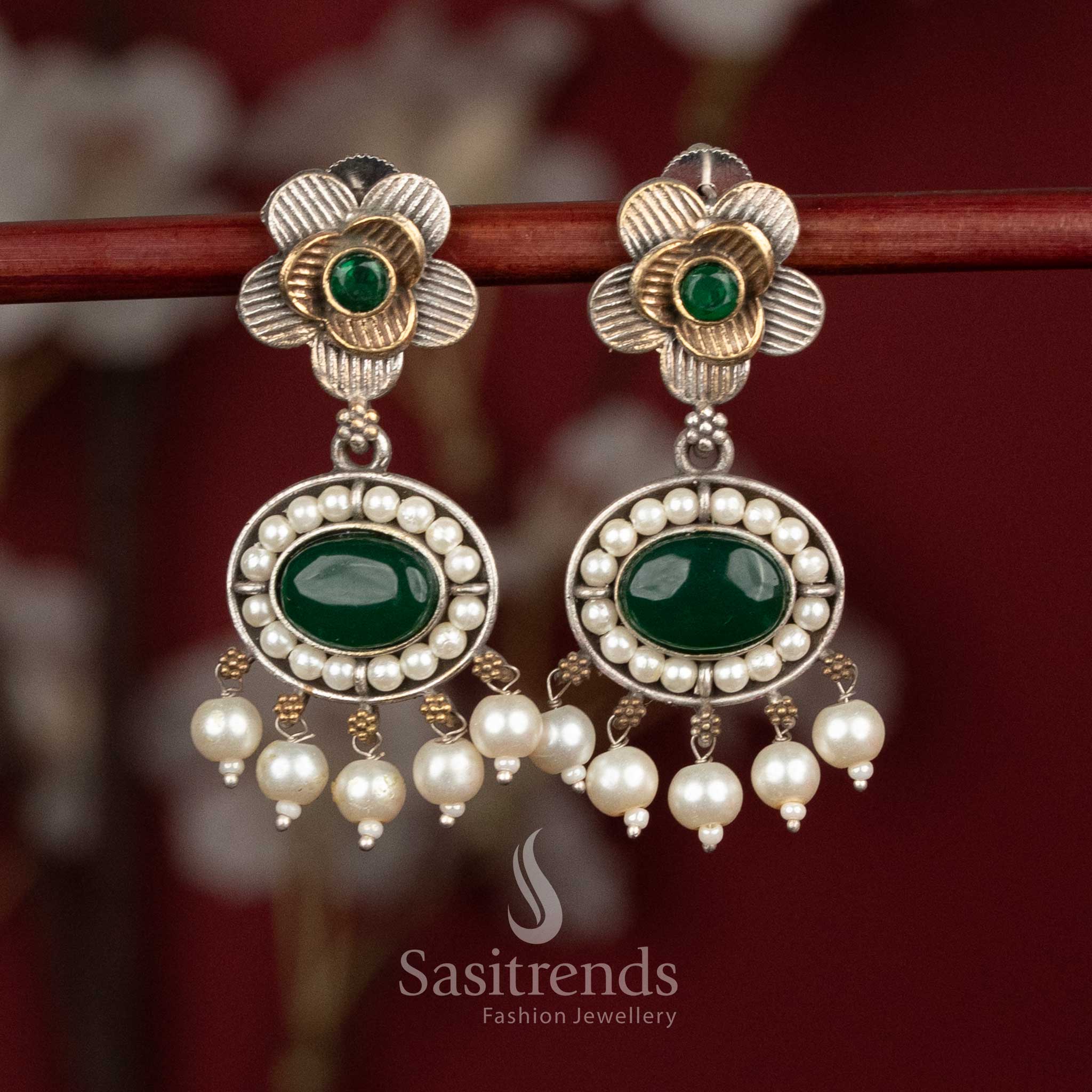 Elegant oxidised silver floral studs featuring green Monalisa stones, sculpted floral motifs and subtle pearl hangings for graceful party wear - Sasitrends