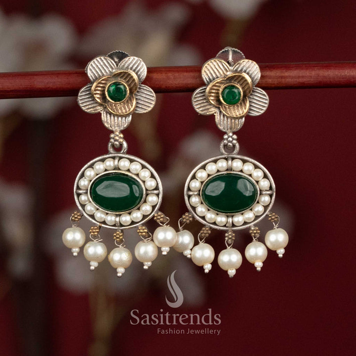 Elegant oxidised silver floral studs featuring green Monalisa stones, sculpted floral motifs and subtle pearl hangings for graceful party wear - Sasitrends