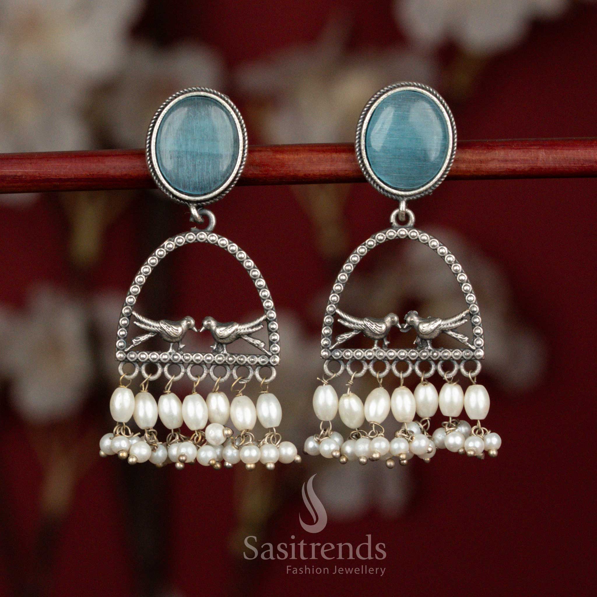 Soft hued oxidised 92.5 silver earrings designed with sky blue Monalisa stone, artistic dual bird arch structure and pearl drops for graceful ethnic wear - Sasitrends