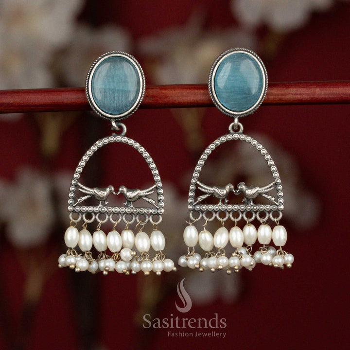 Soft hued oxidised 92.5 silver earrings designed with sky blue Monalisa stone, artistic dual bird arch structure and pearl drops for graceful ethnic wear - Sasitrends