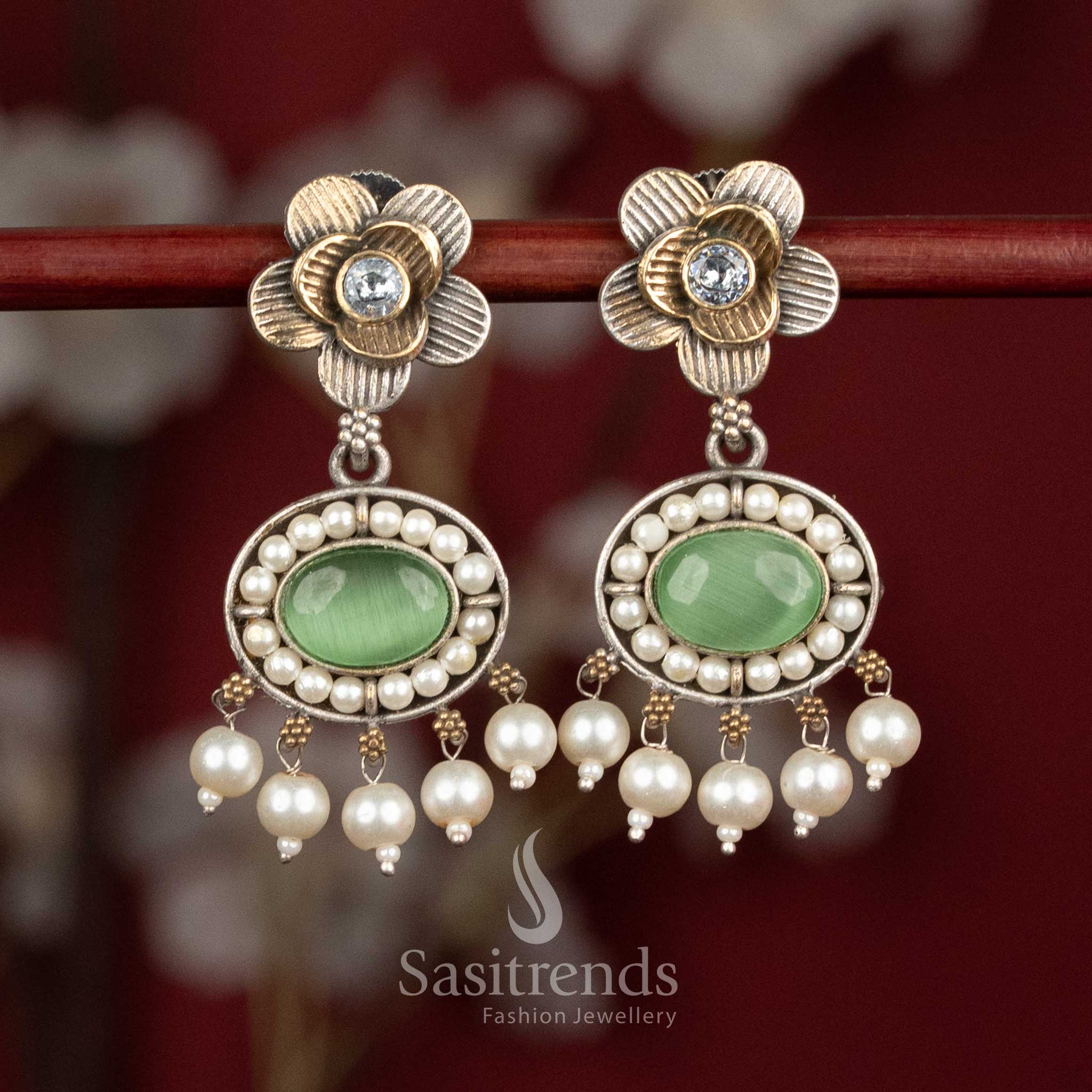 Delicate oxidised silver floral studs featuring white-light-green Monalisa stones, sculpted floral motifs and pearl cluster hangings for graceful festive occasions - Sasitrends