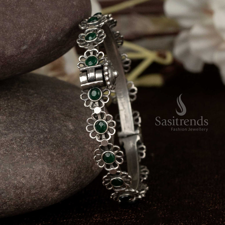 Elegant oxidised kada bracelet with vibrant green stones and floral motif detailing, great for party nights and modern styling – Sasitrends