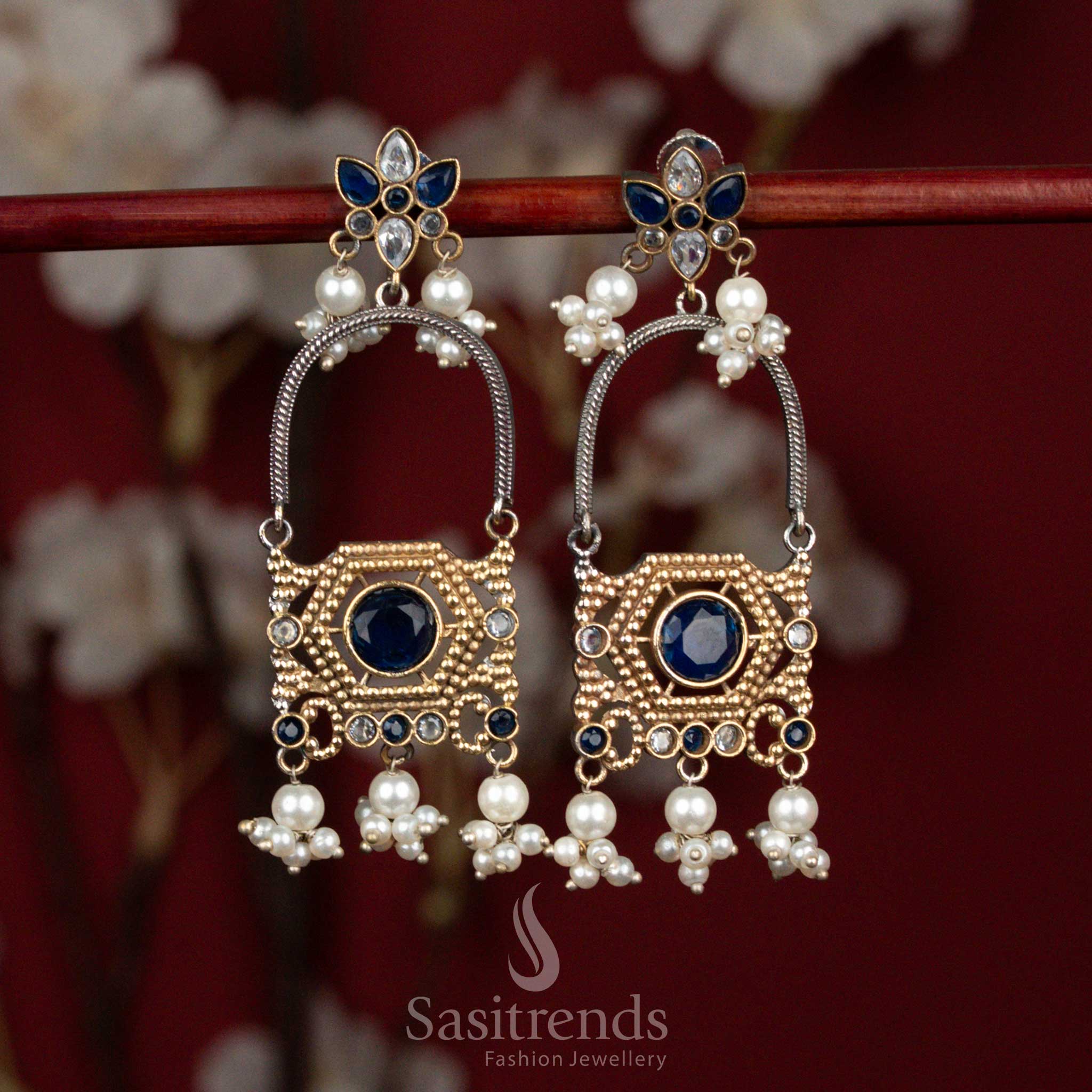 Elegant oxidised silver earrings featuring white-blue Monalisa stones, floral arch design and clustered pearl hangings for refined ethnic styling - Sasitrends