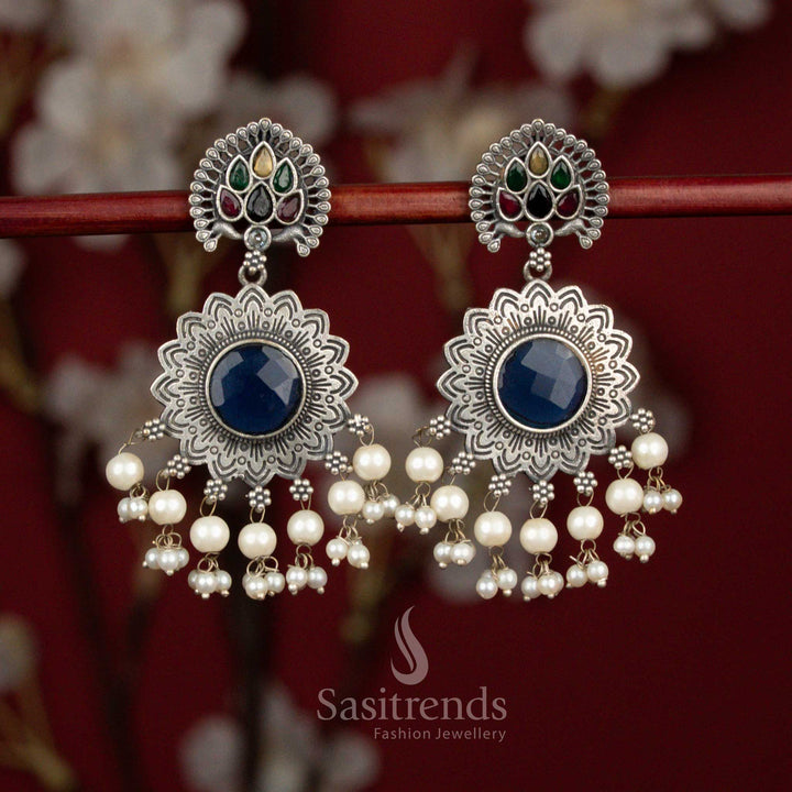 Antique oxidised silver earrings designed with multicolour Monalisa stones, peacock feather sun motif and pearl accents for expressive party wear - Sasitrends