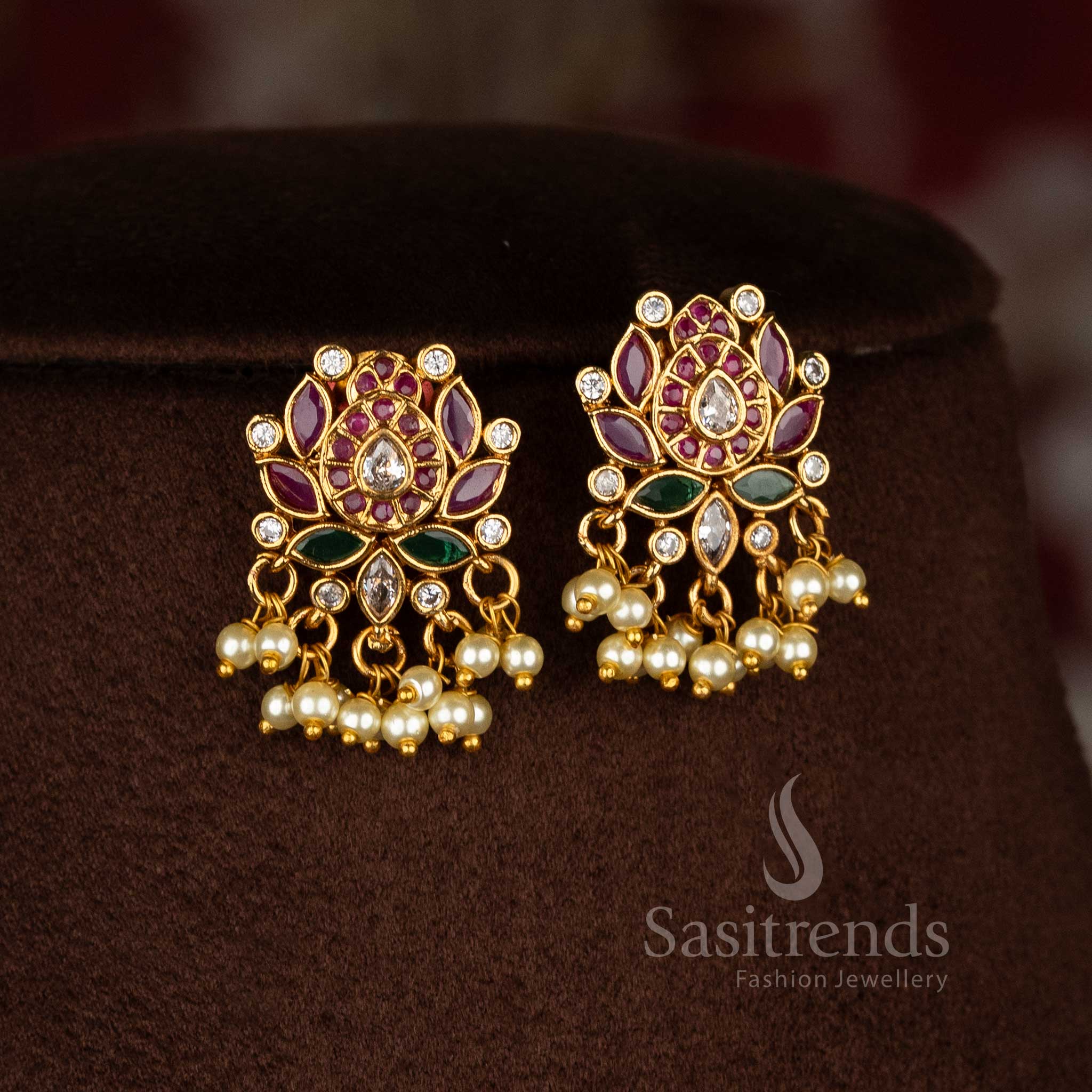 Ethereal tradition temple matte gold tone floral lotus teardrop pearl dangle earrings enhanced with luminous AD stones portraying heritage charm jewellery - Sasitrends