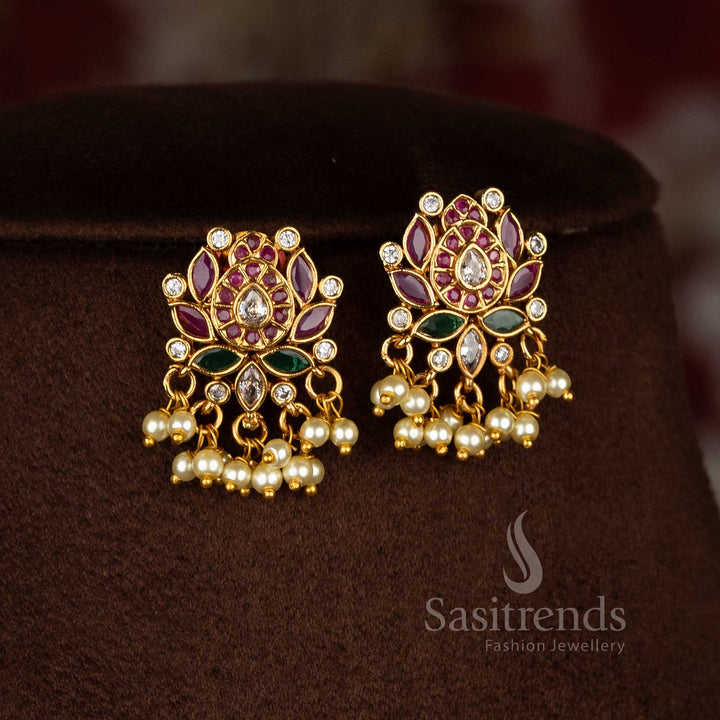 Ethereal tradition temple matte gold tone floral lotus teardrop pearl dangle earrings enhanced with luminous AD stones portraying heritage charm jewellery - Sasitrends