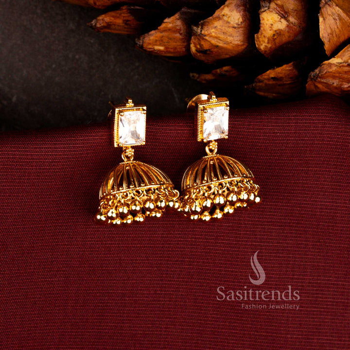 Elegant rectangular stone studded jhumka earrings in white with micro gold plated traditional bell dome design, suitable for festive gatherings, temple ceremonies and cultural occasions – Sasitrends