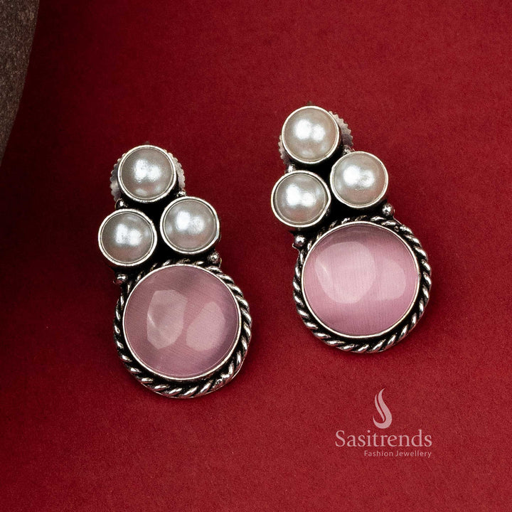 Sophisticated oxidised silver earrings with a delicate pink monalisa stone complemented by a pearl arrangement