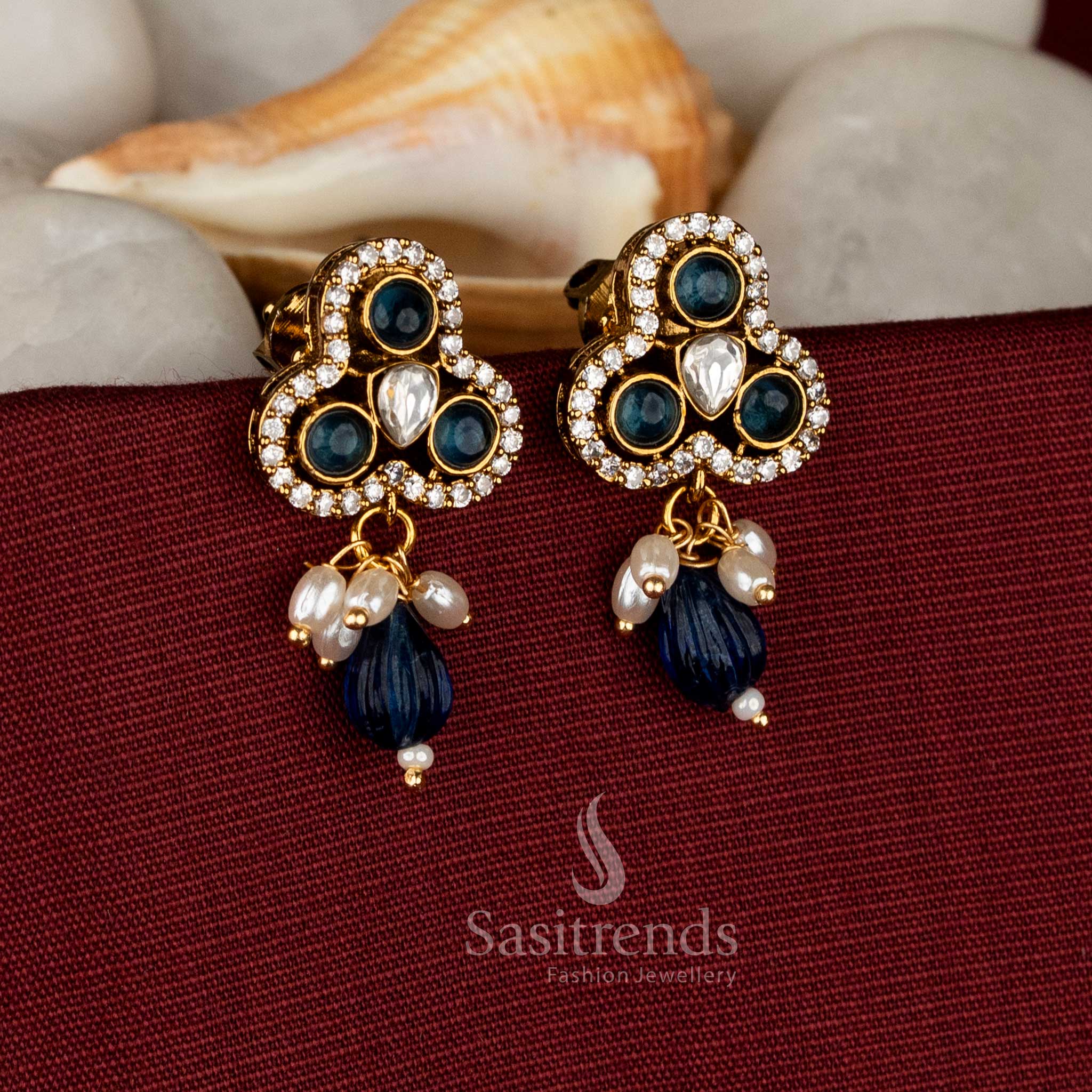 Azure glow Victorian style three-lobed stud earrings adorned with blue AD stones and elegant pearl danglers for classy saree styling – Sasitrends