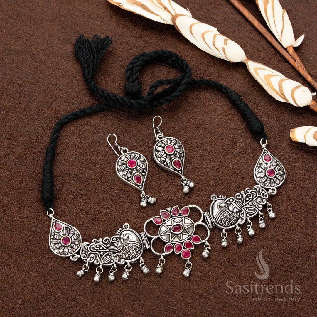 Grand oxidised ruby Navaratri necklace set featuring exquisite peacock engravings, a central floral motif, and classic teardrop stone work, making it a perfect saree jewellery choice for festive occasions  - Sasitrends