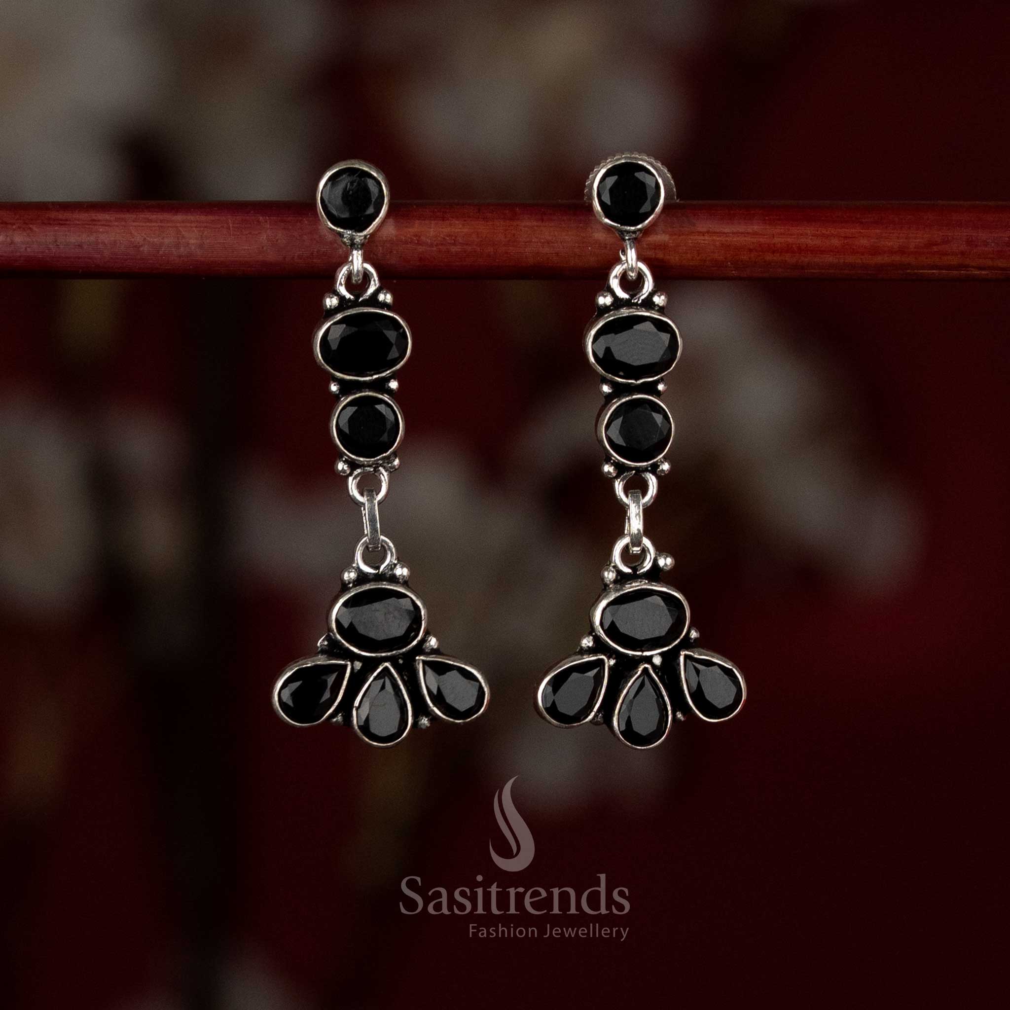 Black oxidised silver earrings designed with linear floral accents and a graceful vertical drop flow – Sasitrends
