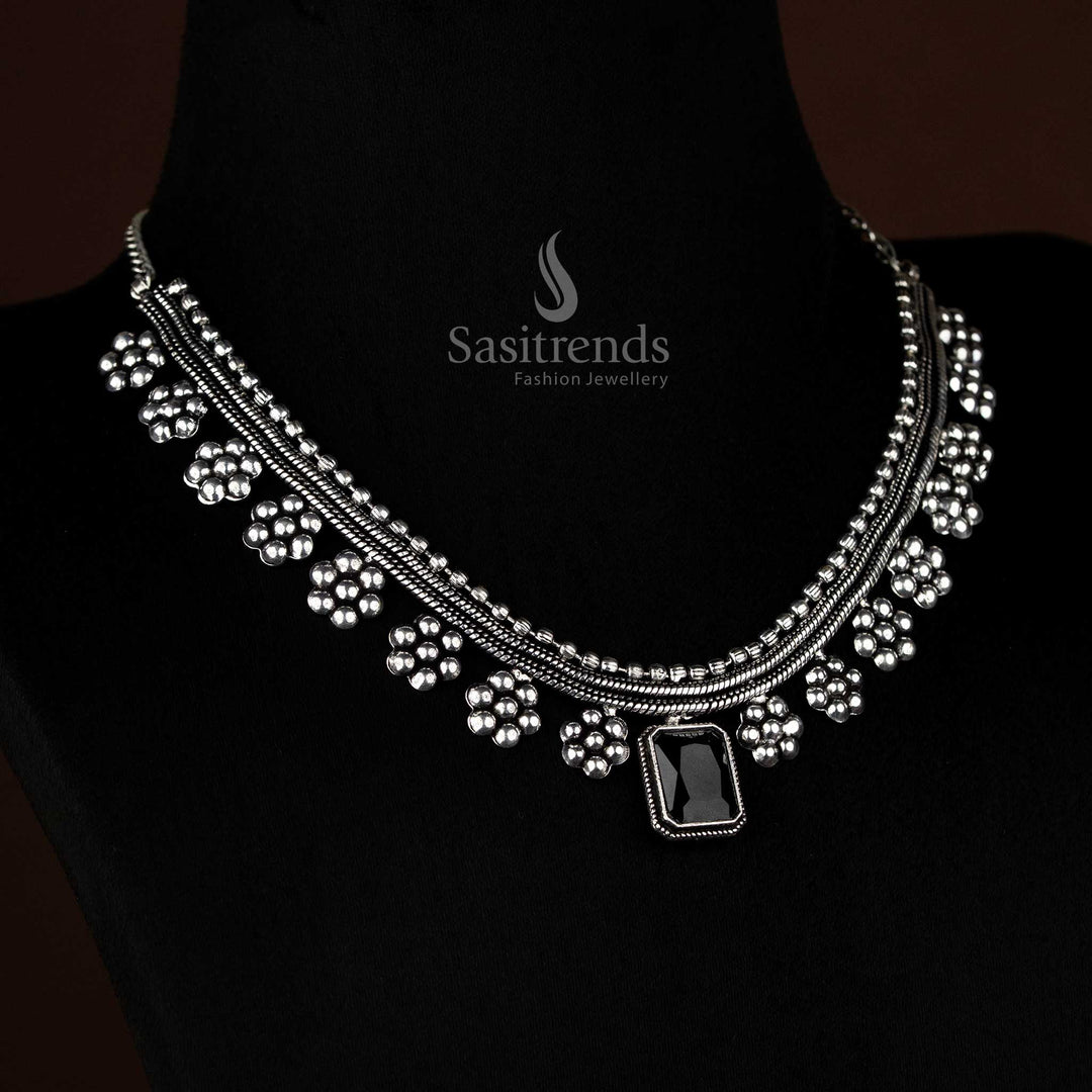 Contemporary oxidised silver necklace with black stone and floral art in an ethnic-fusion look – Sasitrends