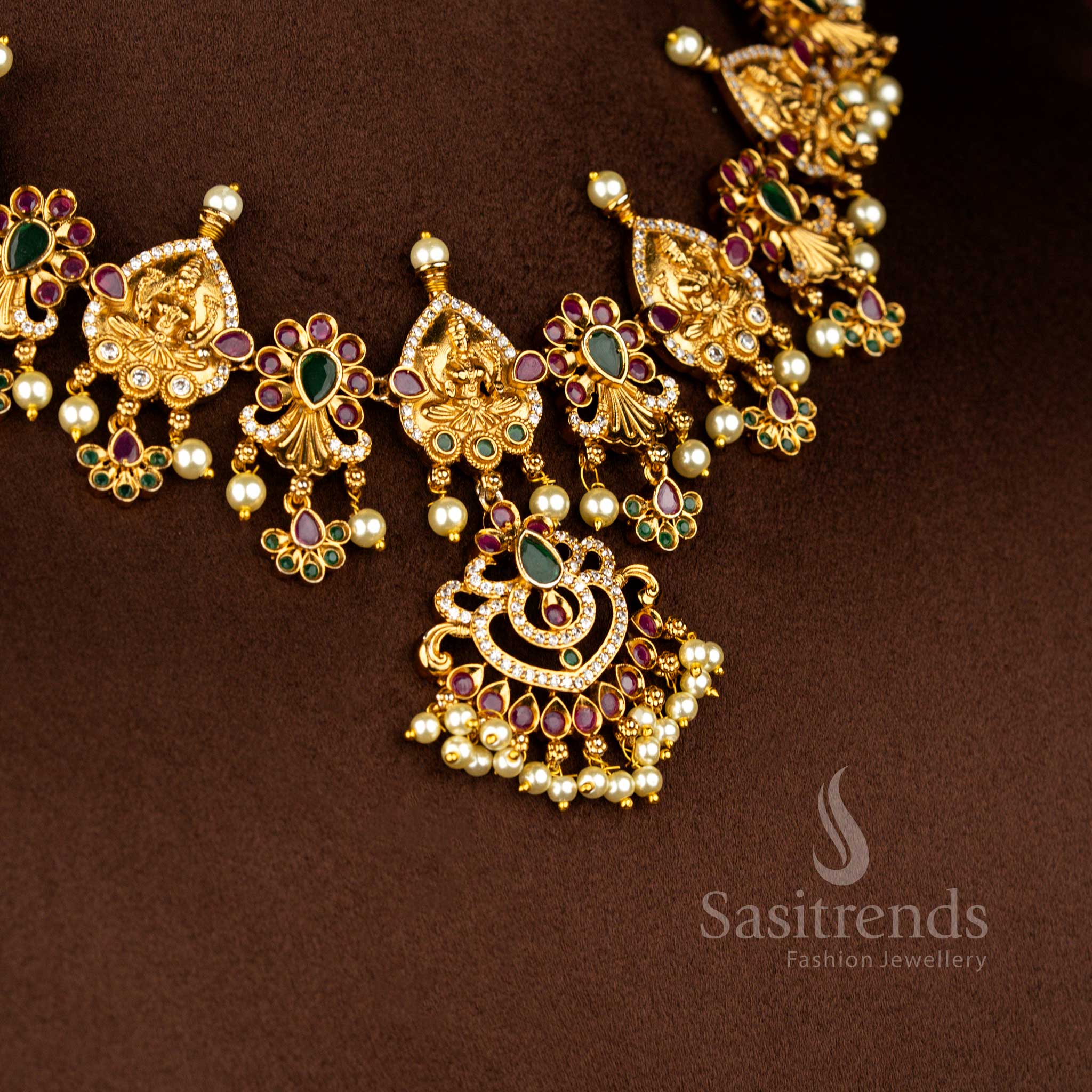 Lakshmi motif temple necklace crafted in matte gold plating featuring American diamond embellishments and pearl highlights in multi shades – Sasitrends
