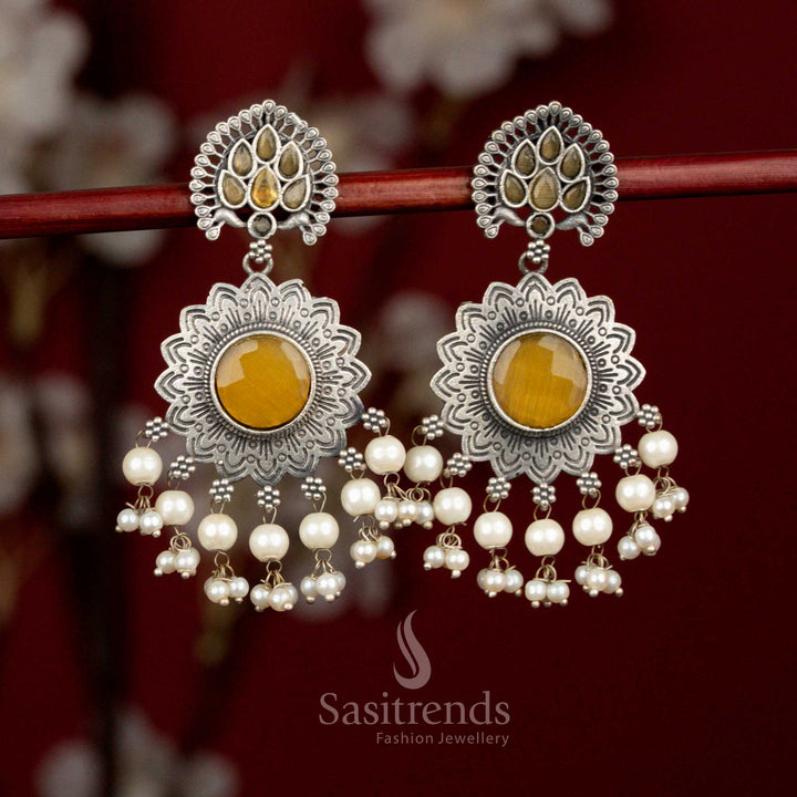 Antique oxidised silver plated earrings with yellow Monalisa stones, radiant peacock feather sun floral motif and pearl detailing for lively party styling - Sasitrends