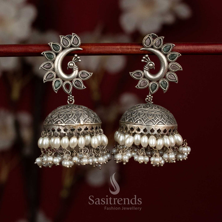 Pastel spark oxidised 92.5 silver pink mint peacock motif dome jhumkas with pearl layers for festive luxe - jewellery - Sasitrends