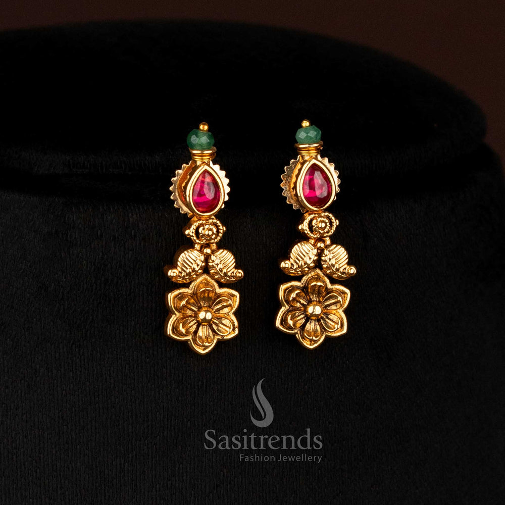 Graceful ruby shade matte gold plated paisley earrings with floral carvings and AD teardrop drops, an elegant adornment for traditional celebrations – Sasitrends.