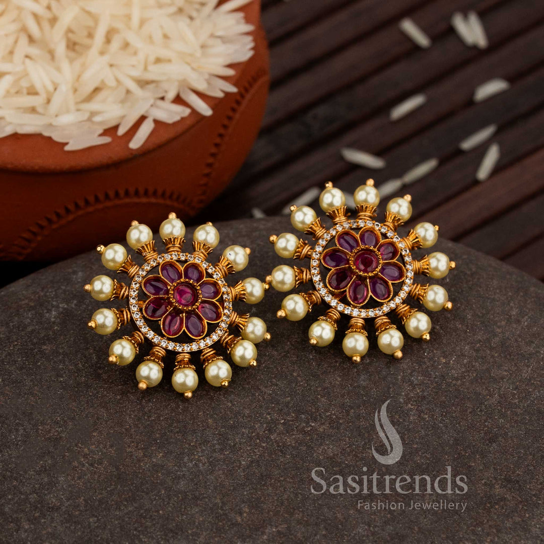 Elegant Matte Gold Plated Floral Round Stud Earrings Featuring A Ruby Pearl Border And Sparkling AD Stone Highlights, A Timeless Traditional Jewellery Piece For Sarees And Bridal Looks – Sasitrends