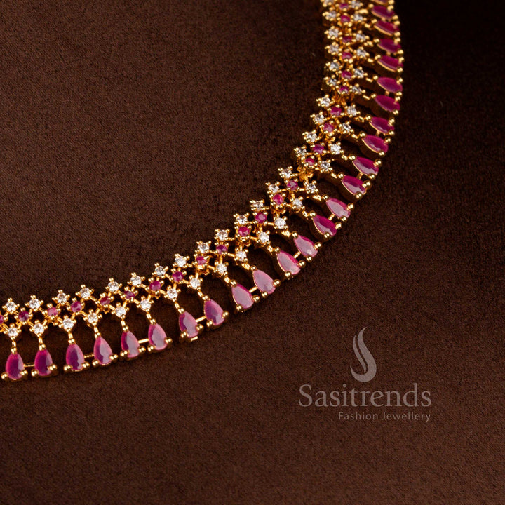 Alluring micro gold plated AD floral necklace in white-ruby combination featuring round and pear shaped stones – Sasitrends