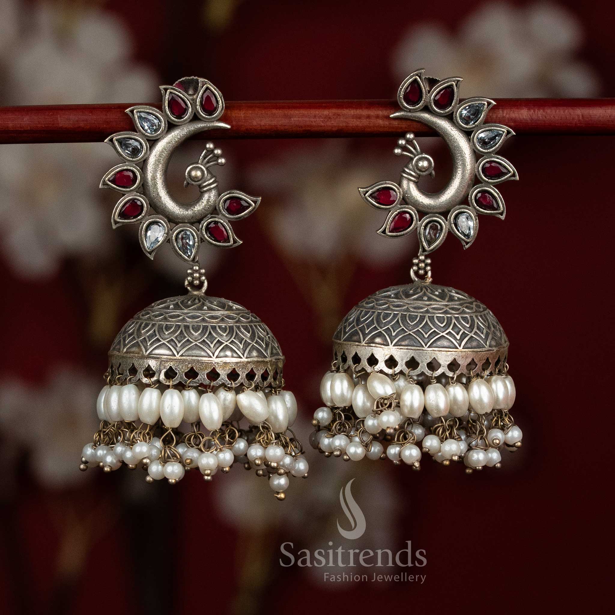 Scarlet pearl oxidised 92.5 silver ruby white peacock motif dome jhumkas with pearl layers for party glow - jewellery - Sasitrends