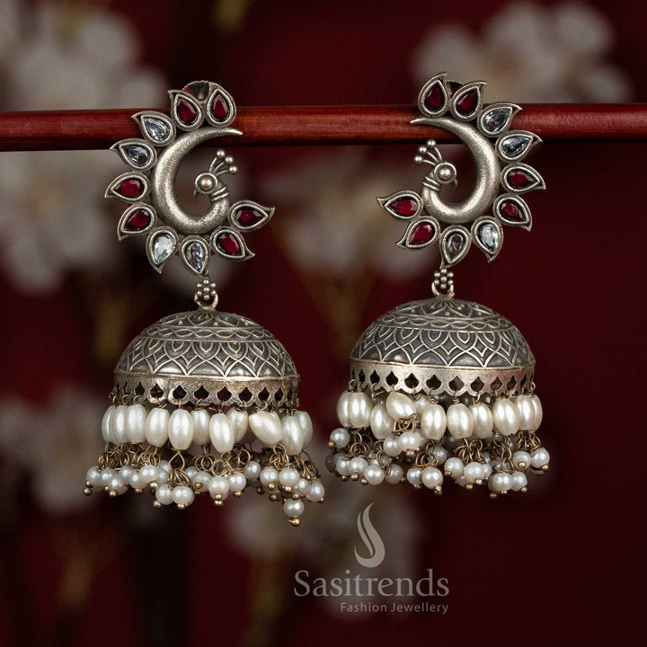 Scarlet pearl oxidised 92.5 silver ruby white peacock motif dome jhumkas with pearl layers for party glow - jewellery - Sasitrends