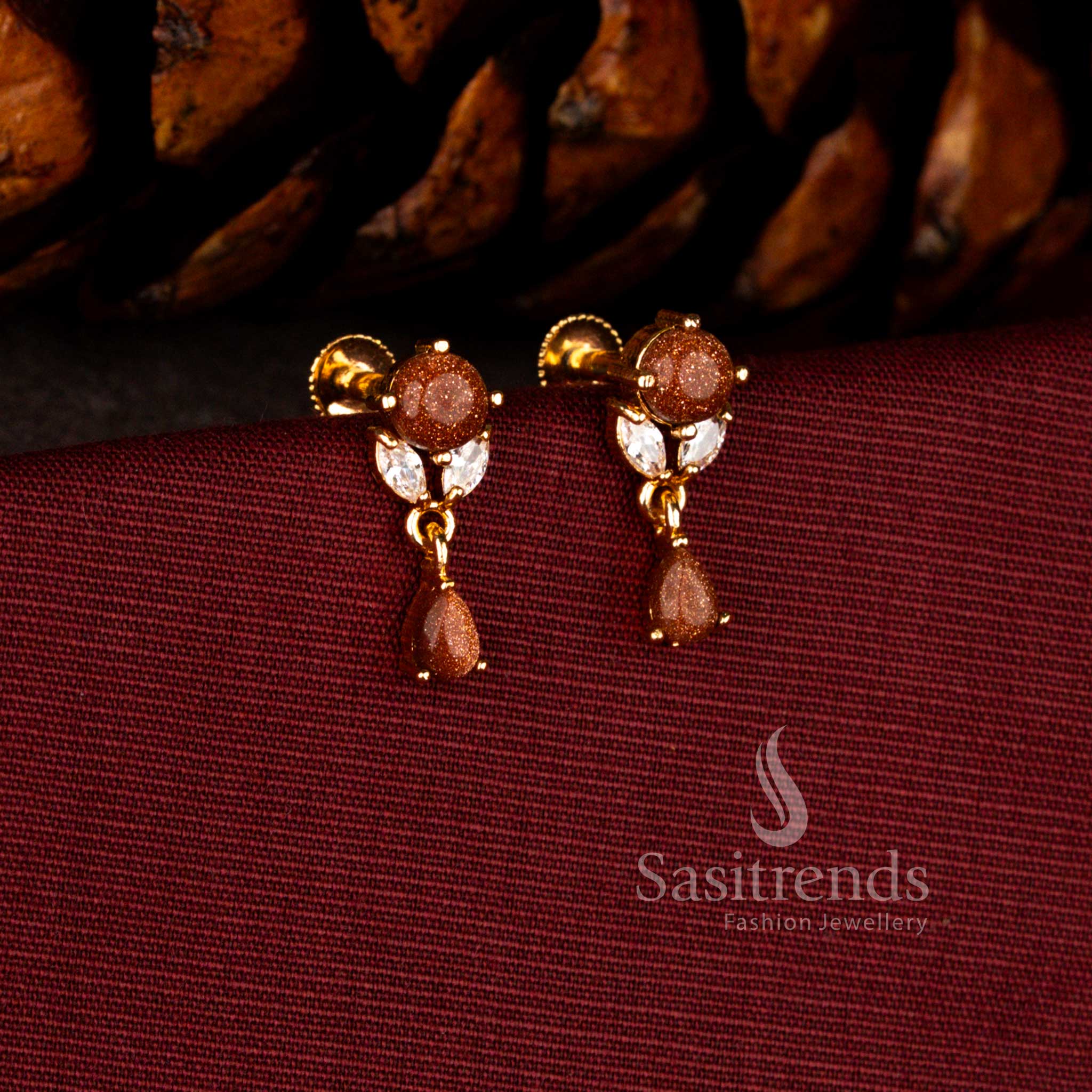 Royal gold look earrings in white-brown crafted with sparkling floral AD cluster and luminous brilliant teardrop styling – Sasitrends