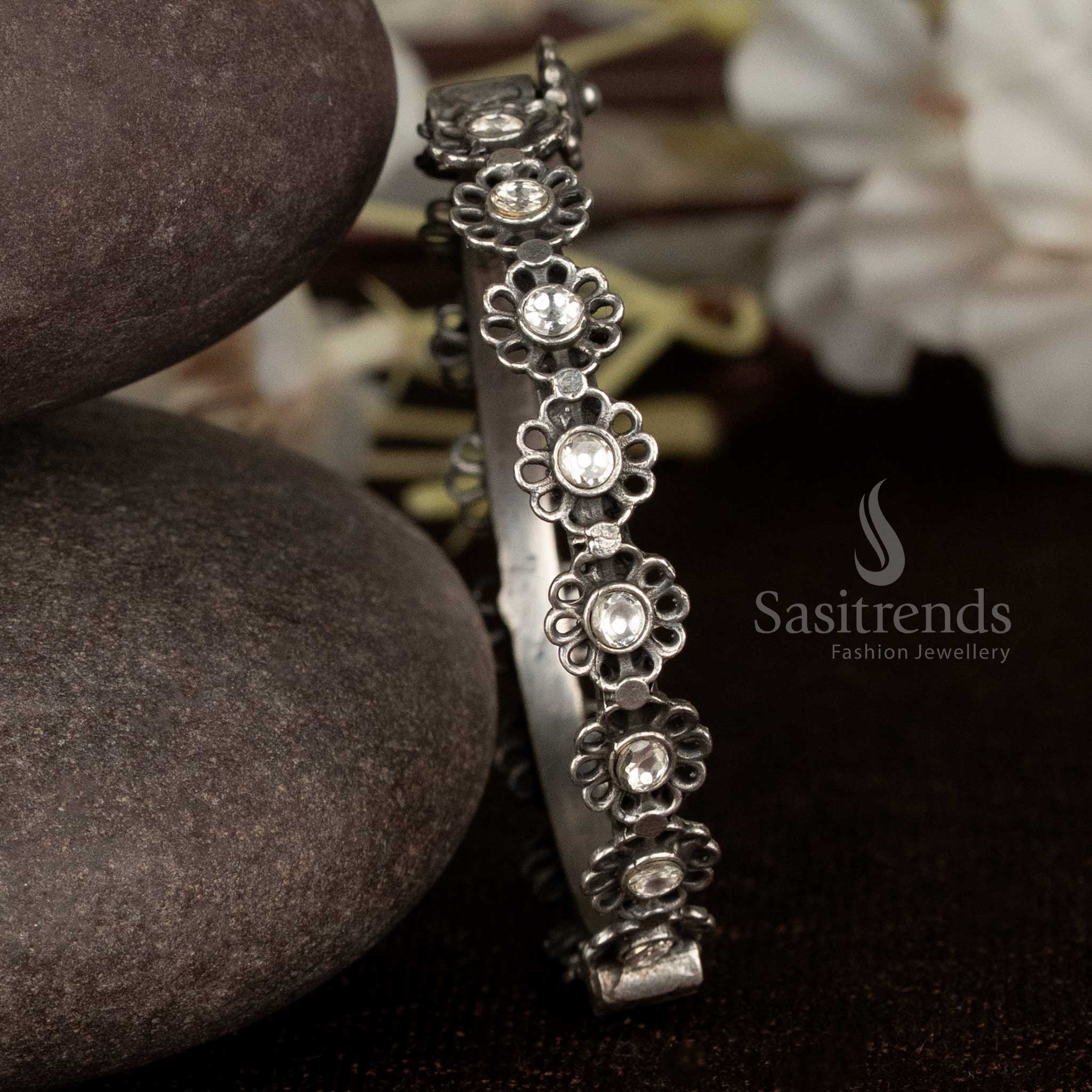 Elegant oxidised bracelet with white crystal floral detail, openable and ideal for modern party wear and designer looks – Sasitrends
