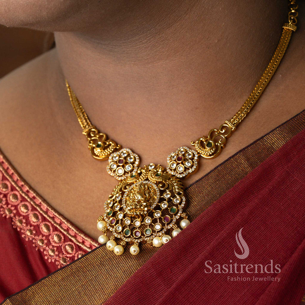Grand Temple Matte Gold Lakshmi Pendant Necklace Jewellery Set with Sparkling AD Stones and Dangling Pearls – Classic Bridal Temple Jewellery Styled on Model  - Sasitrends