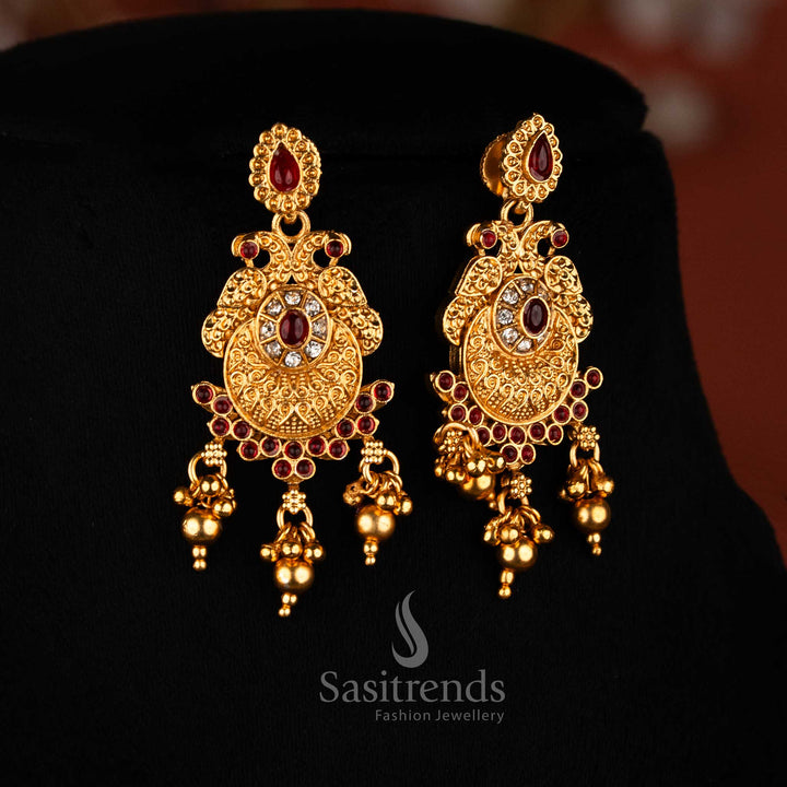 White-ruby dual peacock earrings with classic matte gold plating, oval and teardrop stones, golden beads for traditional festive jewellery – Sasitrends
