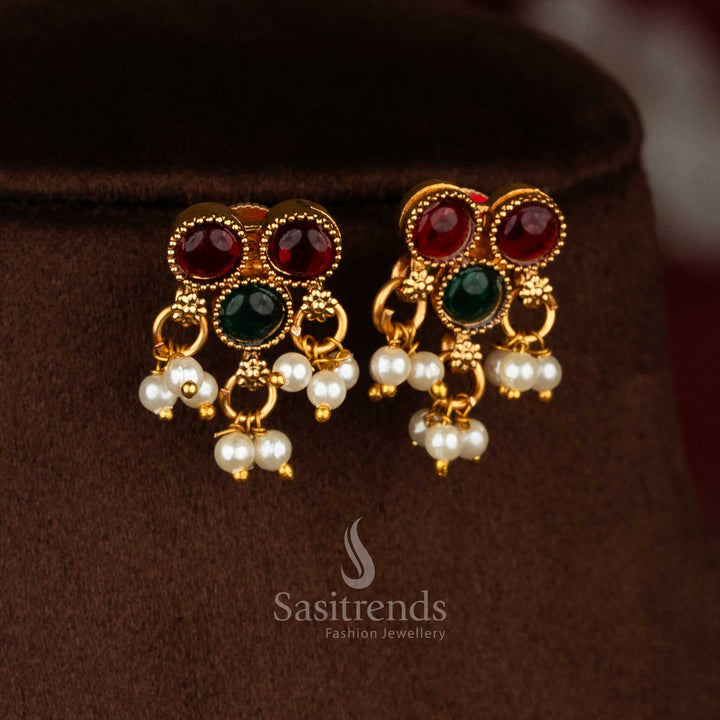 Classic matte gold plated temple earrings with ruby green round stone pendants, pearl drops and flexible chain for ethnic elegance - Sasitrends