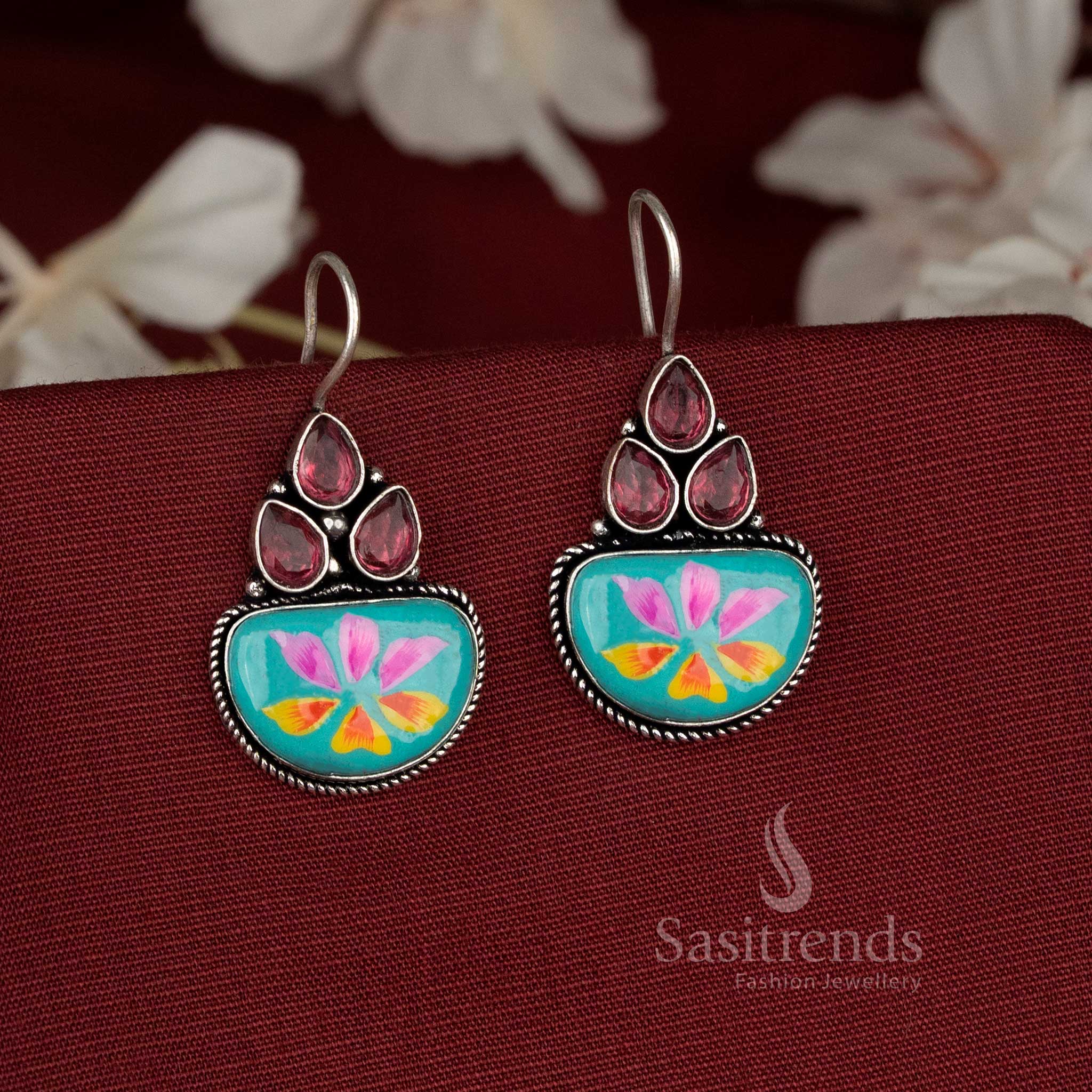 Skywave oxidised earrings styled with sky blue Monalisa stones and soft floral hand-paint strokes – Sasitrends