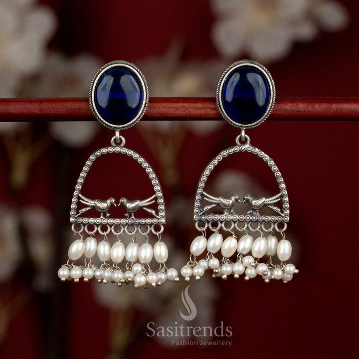 Antique oxidised silver earrings featuring blue oval Monalisa stone, spherical arch dual bird form and rice pearl hangings for graceful cultural styling - Sasitrends