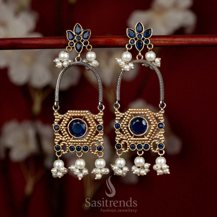 Antique oxidised silver earrings adorned with blue Monalisa stones, sculpted floral arch motifs and delicate pearl cluster drops for festive cultural wear - Sasitrends