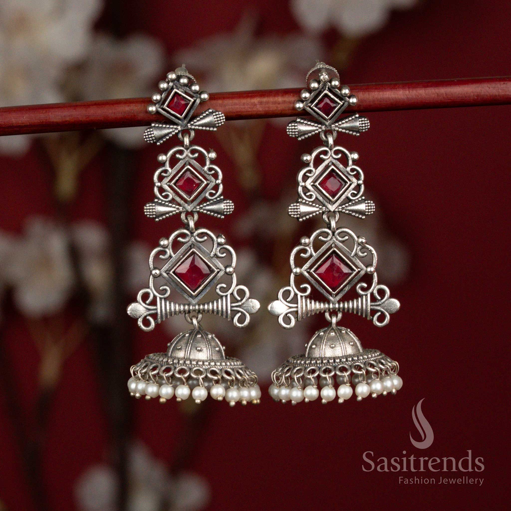 Deep ruby oxidised 92.5 silver geometric long jhumka earrings with stone accents and pearl drops for ethnic styling - jewellery - Sasitrends