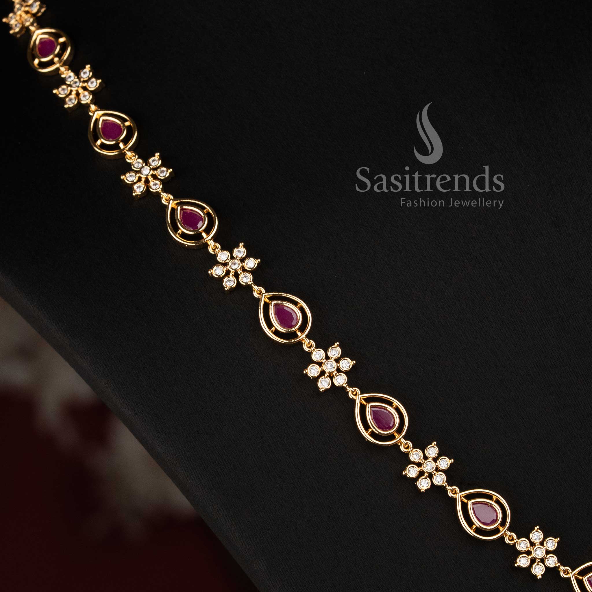 Sasitrends micro gold plated AD stone necklace set designed with floral clusters, rounded frames, pear-shaped elements and coordinated earrings 