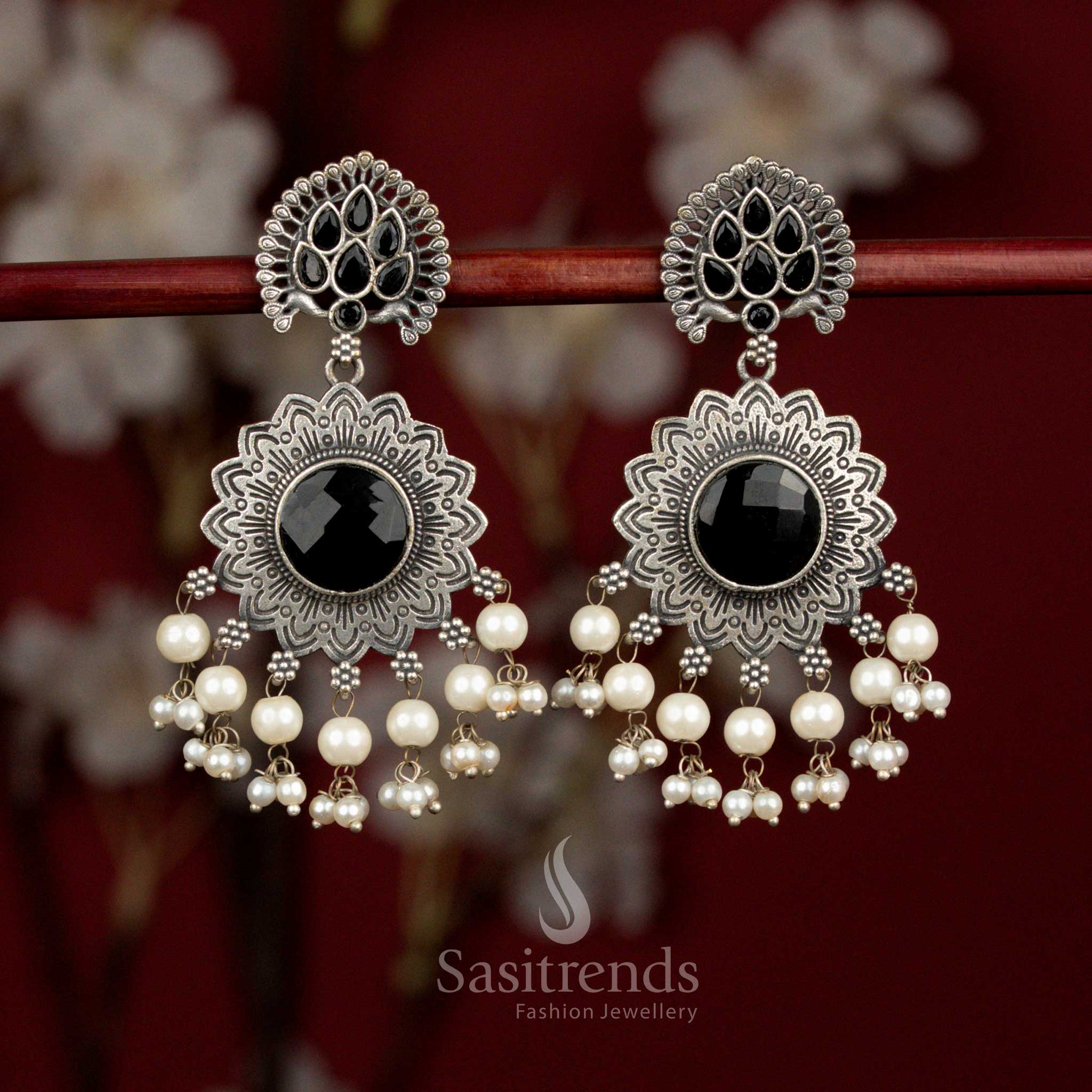 Bold antique oxidised silver earrings crafted with black Monalisa stones, dramatic peacock feather sunburst motif and pearl drops for standout styling - Sasitrends