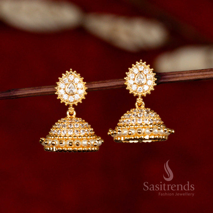 Classy white colour jhumka earrings with antique-inspired AD stones and refined pearl charm – Sasitrends