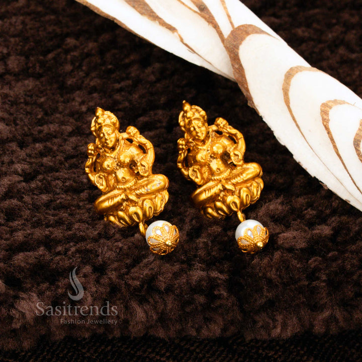 Exquisite Matte Gold Plated Lakshmi Pearl Drop Earrings featuring detailed temple artistry – Ideal for bridal and festive saree looks – Sasitrends
