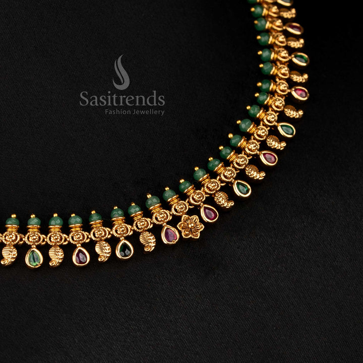 Majestic matte gold plated paisley and floral motif necklace in ruby-green tones with temple art essence, suited for grand celebrations – Sasitrends