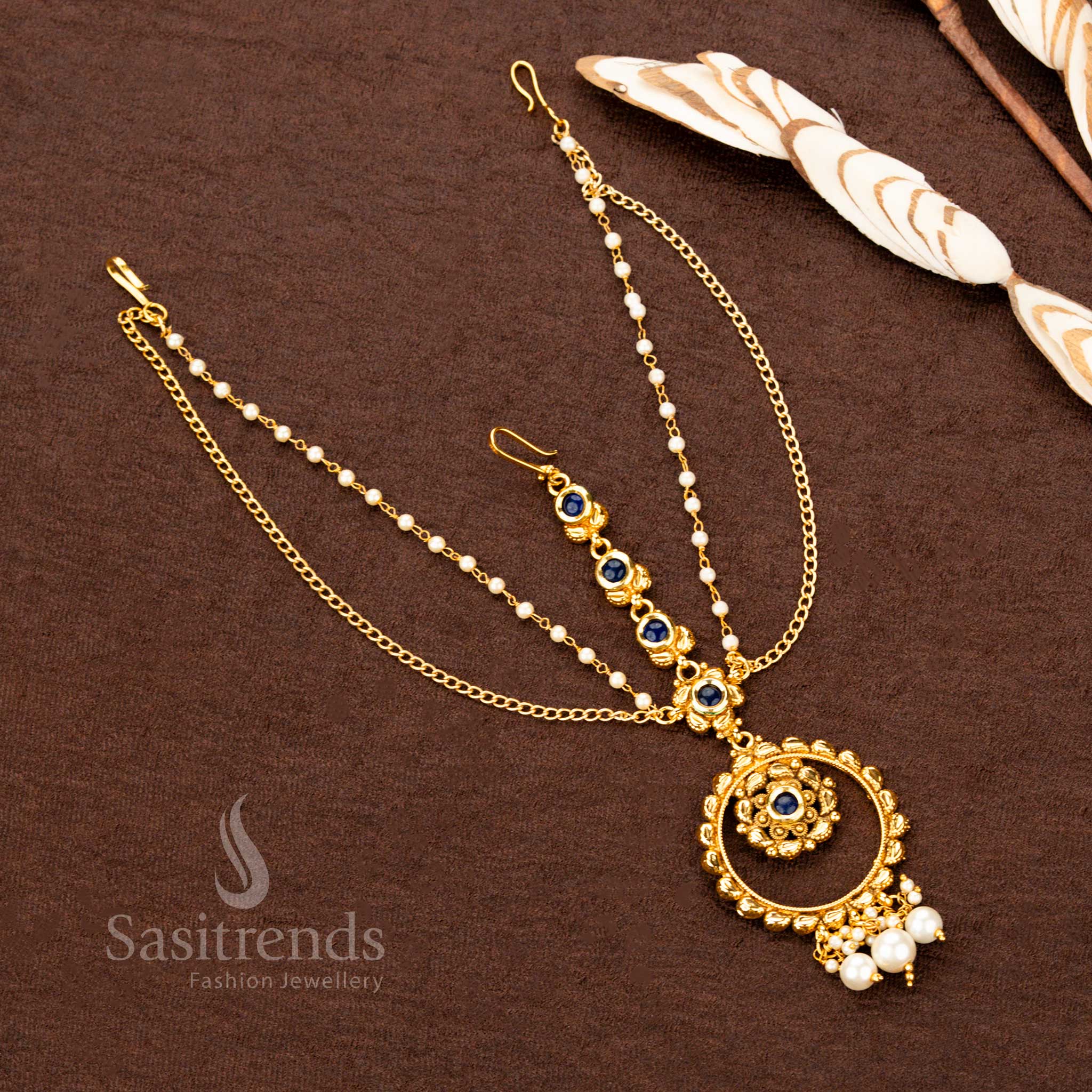 Opulent antique gold plated blue stone layer tikka crafted for wedding elegance, enhancing saree festive looks with temple jewellery artistry – Sasitrends