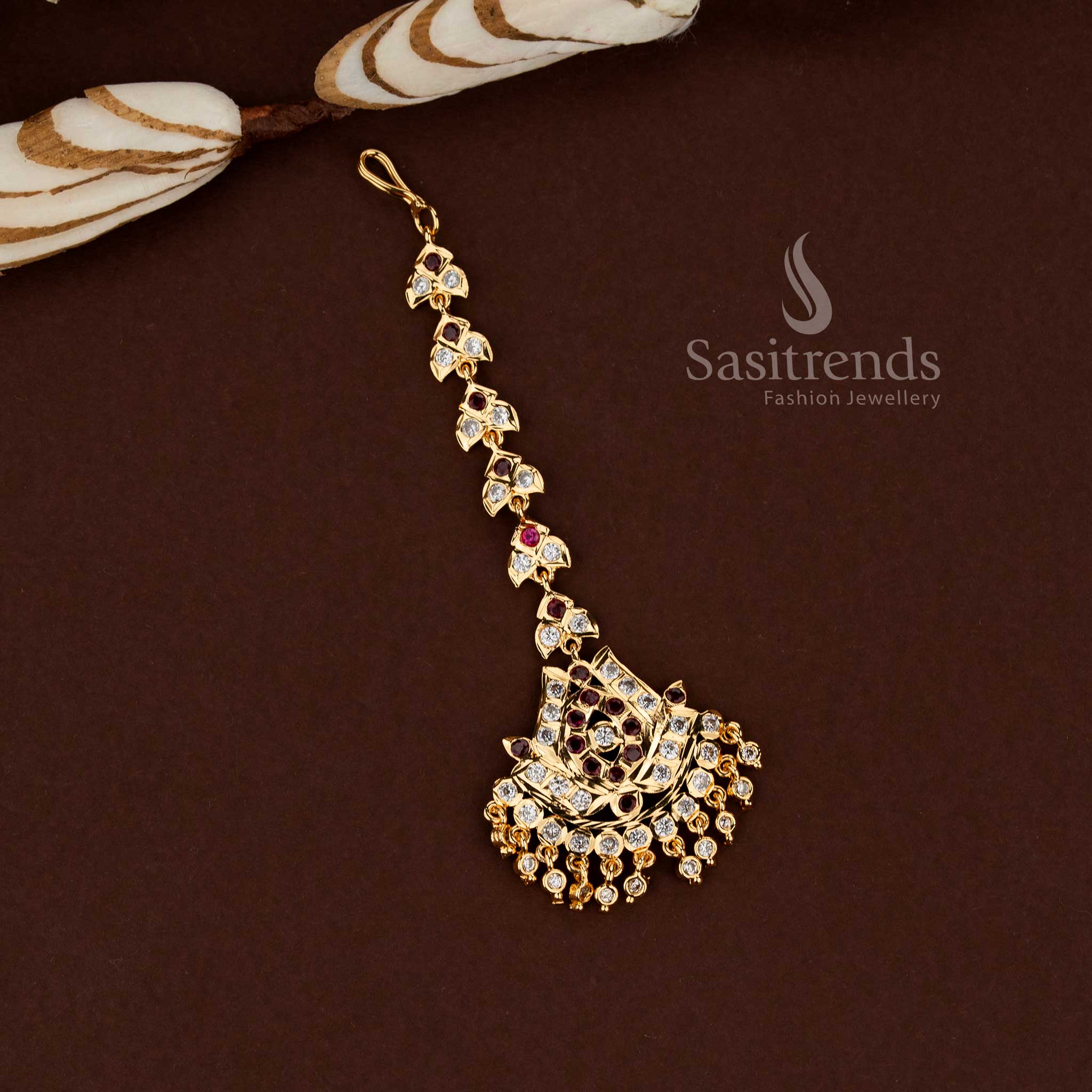 Divine white and ruby lotus motif Impon micro gold plated American diamond maang tikka crafted for wedding occasions bridal styling and festive ethnic wear - Sasitrends