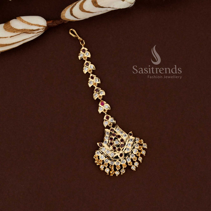 Divine white and ruby lotus motif Impon micro gold plated American diamond maang tikka crafted for wedding occasions bridal styling and festive ethnic wear - Sasitrends