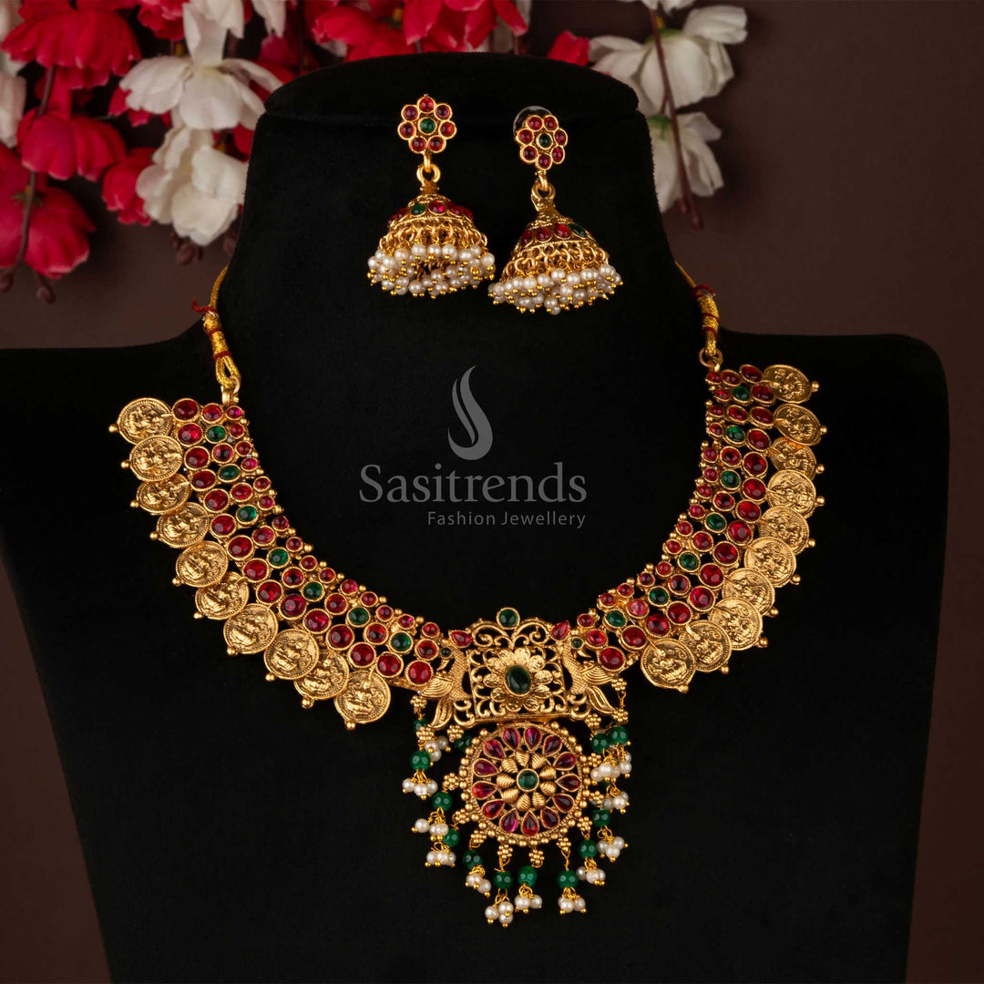 Temple-inspired classic short necklace set in matte gold featuring a floral pendant and bold jhumka earrings – an expressive traditional jewellery ensemble ideal for bridal occasions and richly woven saree looks – Sasitrends