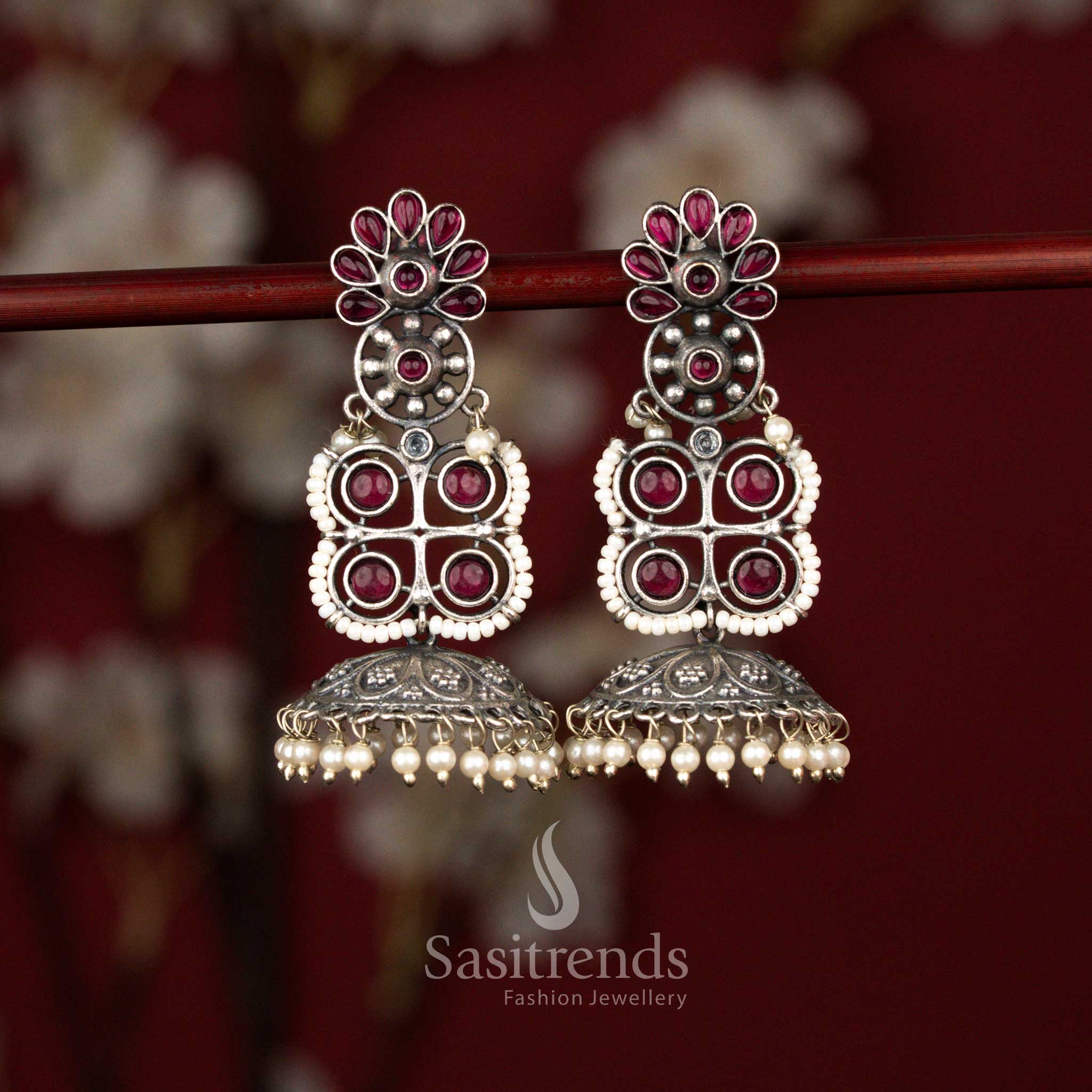 Majestic oxidised floral and geometric jhumka earrings with ruby stones and pearl bell drops ideal for sarees and festive wear – Sasitrends