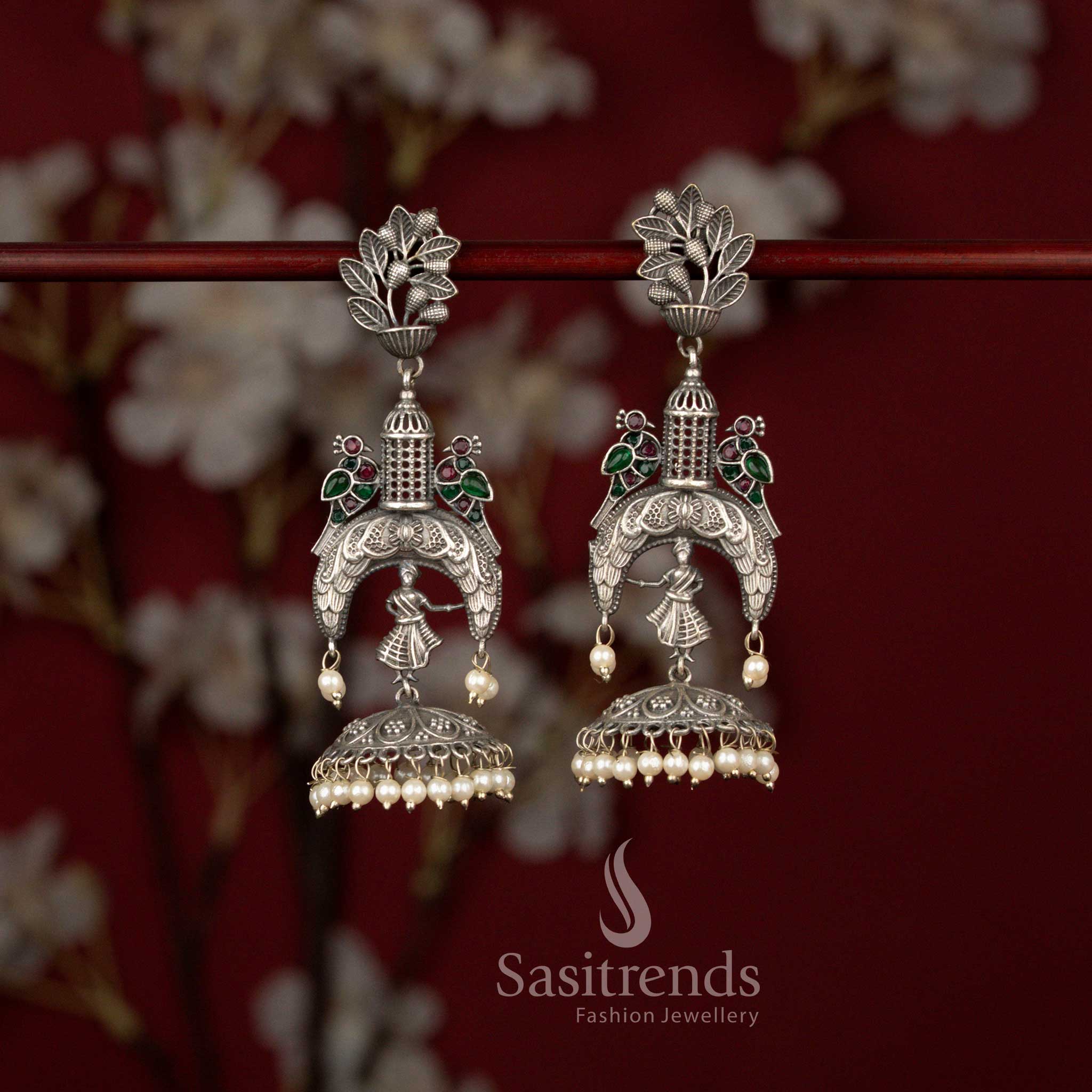 Opulent oxidised silver plated jhumka earrings with temple dancer motif, floral top, ruby green stones and pearl drops suited for weddings and grand celebrations – Sasitrends