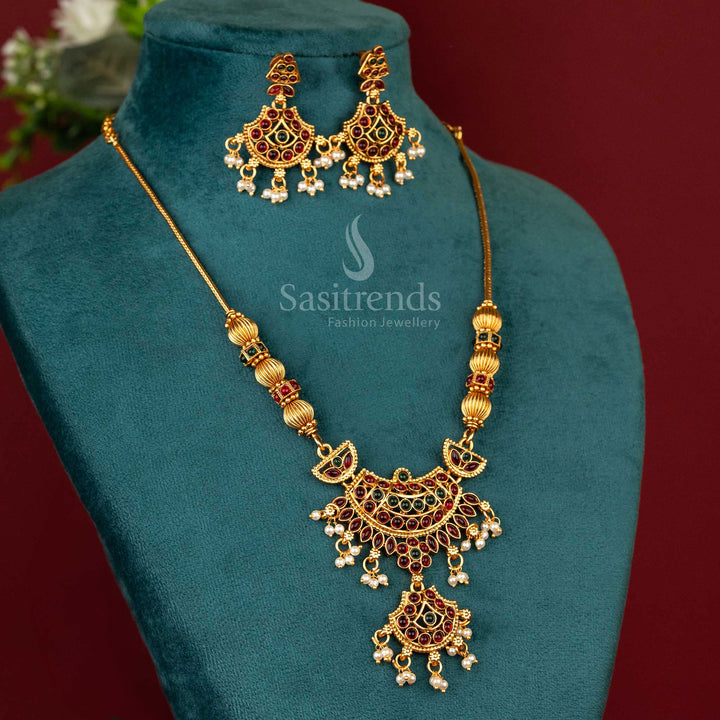 Handcrafted temple-style necklace with a lotus-inspired ruby-green pendant, adorned with matte gold carvings and traditional South Indian elegance – Sasitrends