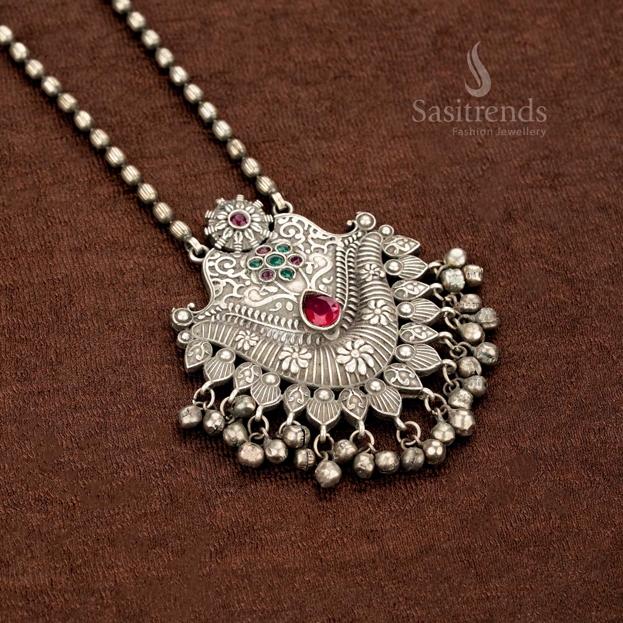 Oxidised necklace in German silver with a ruby-green duo stone pendant, intricate floral etchings, and antique ball drops – a heritage-style jewellery creation by Sasitrends
