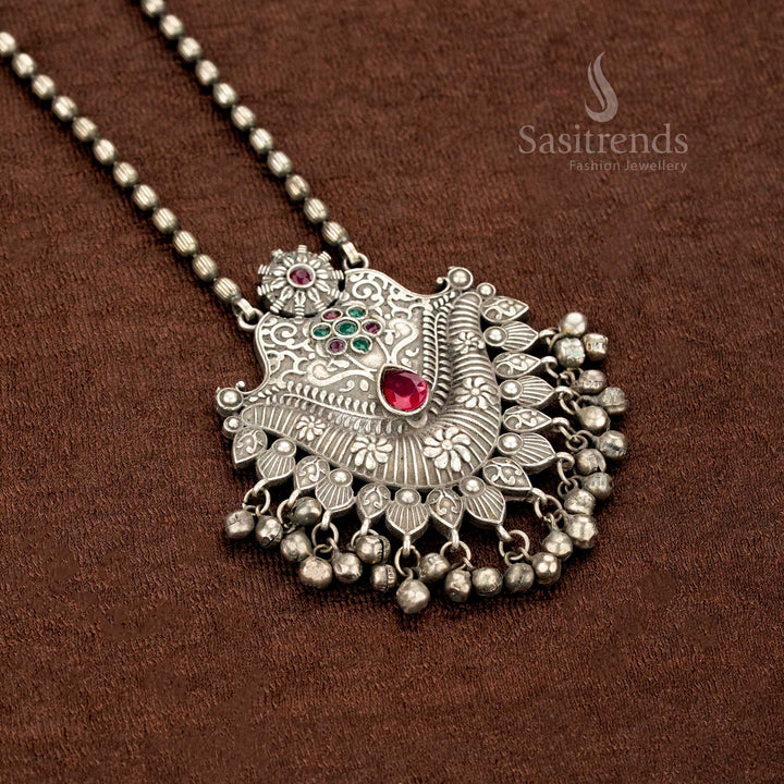 Oxidised necklace in German silver with a ruby-green duo stone pendant, intricate floral etchings, and antique ball drops – a heritage-style jewellery creation by Sasitrends